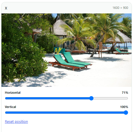 Tropical beach resort with sun loungers and palm trees on white sand